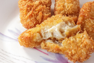 Fried fish fillet on dish.