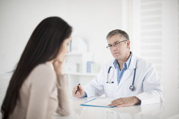 senior  doctor consulting female patient