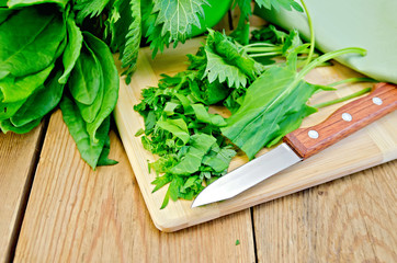 Sorrel and nettles sliced on the board with a knife