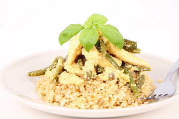 Brown rice with chicken & green beans decorated with basil