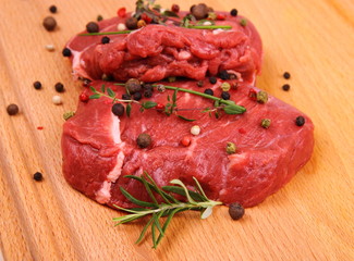 Two juicy beef steak with spices and herbs