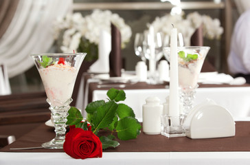 ice cream and red rose on decorated table