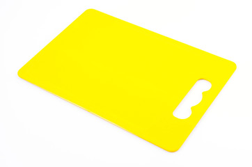 Yellow plastic cutting board on isolated white background