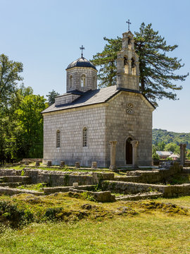 old church with a belfry on the forest background
