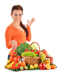 Young woman with assorted vegetables isolated on white