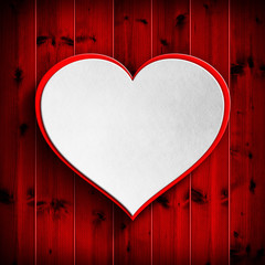 White heart on red wooden background