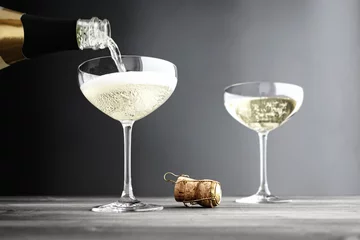 Foto auf Acrylglas Alkohol Champagne being filled in Coupe Glasses