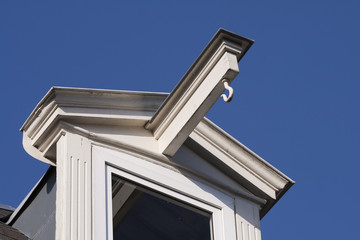 White dormer on a blue sky.
