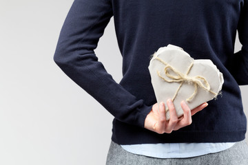 Woman Hiding Valentine's Gift Behind Back