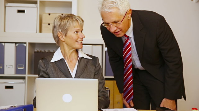 Business man helping woman in office