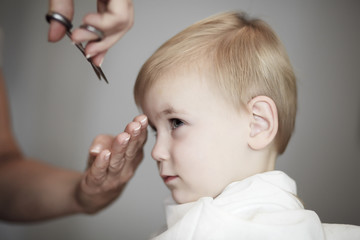Little girl having her fist time at hairdresser
