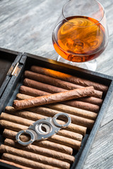 Humidor full of cigars, guillotine and cognac