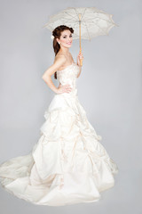 beautiful elegant woman in a white wedding dress posing