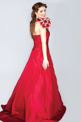 beautiful elegant bride in a red wedding dress posing