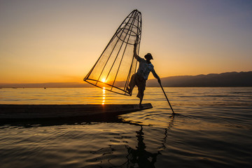 A local fisherman is fishing by boat, Inle lake, Myanmar.