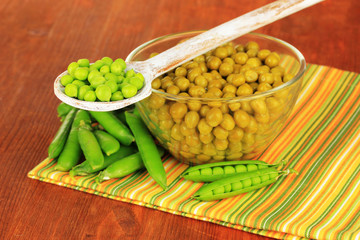 Green peas on wooden background