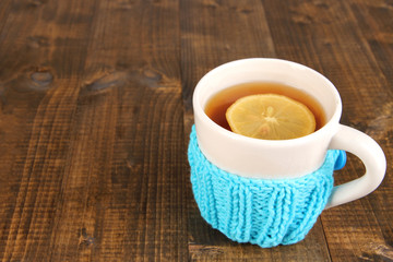 Cup of tea with lemon on wooden table