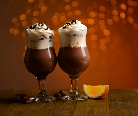 Tasty dessert with chocolate, cream and orange sauce,