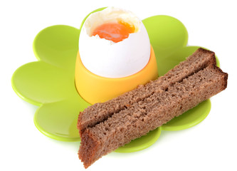 Boiled egg in egg cup isolated on white