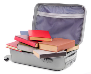 Suitcase with books isolated on white