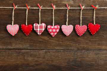 Gingham Love Valentine's hearts hanging on wooden texture backgr