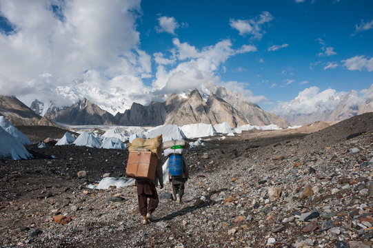 Porters carrying heavy loads in Karakoram range, Pakistan