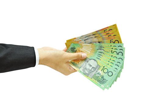 Hand holding money - Australian dollars