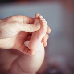 Mother making massage of child's foot