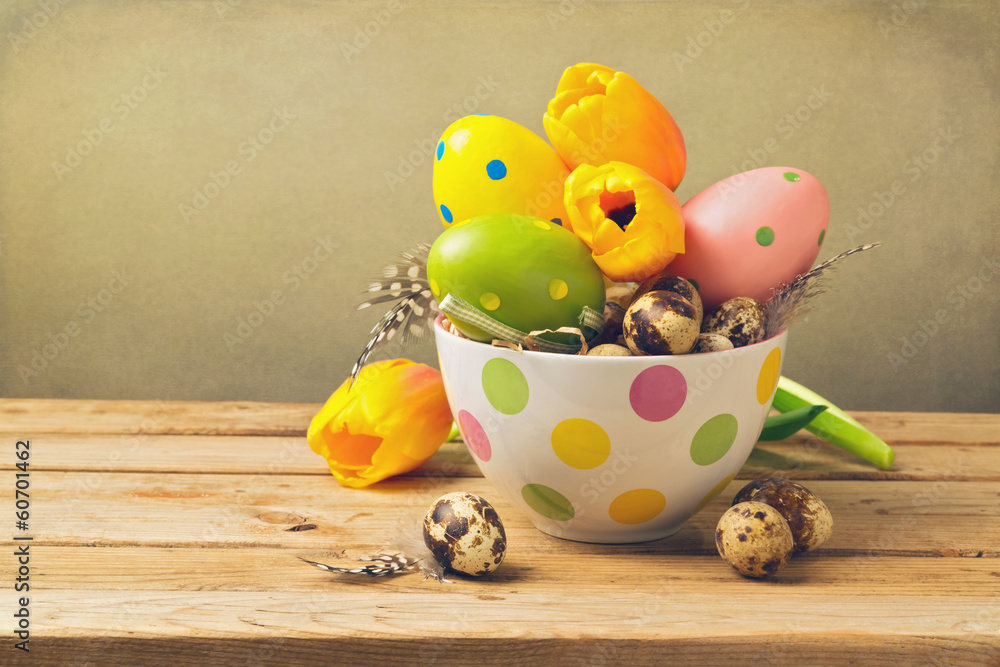 Wall mural easter eggs and quail eggs in bowl on wooden table