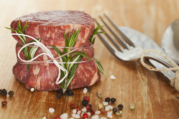 fresh raw beef fillet mignon on old  wooden background