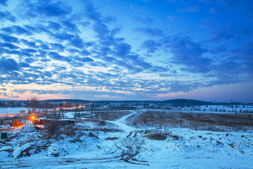 Winter sunset over snowy meadow in Poland
