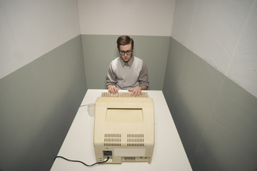 Vintage nerd on computer - obrazy, fototapety, plakaty