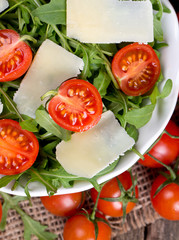 fresh salad from rucola, cherry tomatoes and parmesan cheese