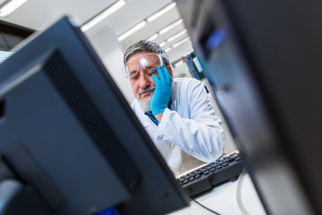 Senior male researcher carrying out scientific research in a lab