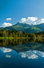 Wharf by the Schwarzsee in Austria with mirror reflection