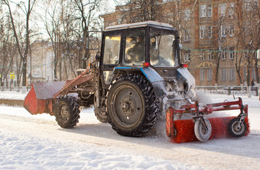 Tractor cleaning snow