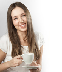 Young beautiful woman holding a mug of coffee