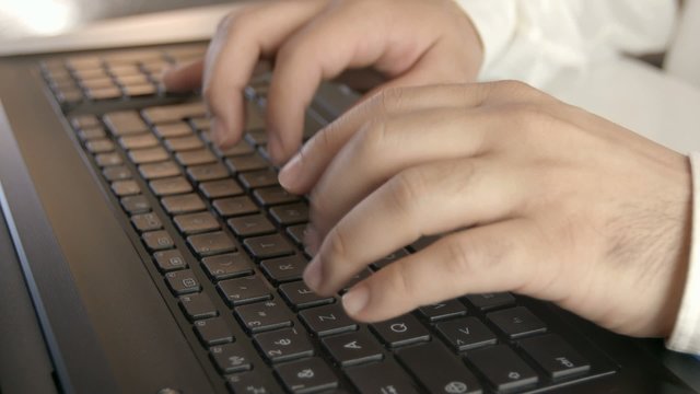 Man hands typing on computer keyboard.