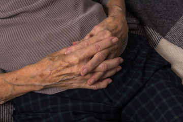 Joined hands of an old woman