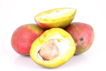 Mango fruits, one cut in half