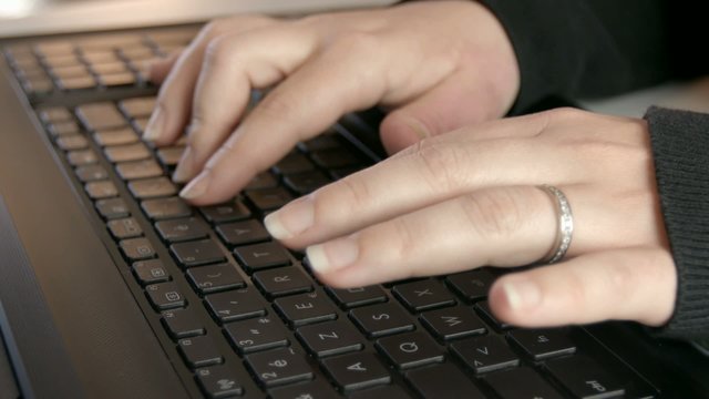 Woman hands typing on computer keyboard.