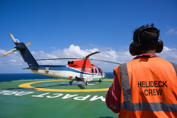 Helicopter with helicopter crew on oil rig helipad