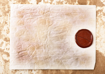 sheet of old paper with a wax seal on old paper background