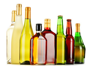 Bottles of assorted alcoholic beverages isolated on white