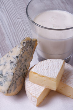 milk in a glass, brie and blue cheese close up