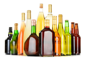 Bottles of assorted alcoholic beverages isolated on white