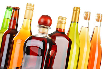 Bottles of assorted alcoholic beverages isolated on white