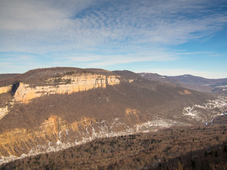 Panorama of mountain ridge on a background of clouds and trees