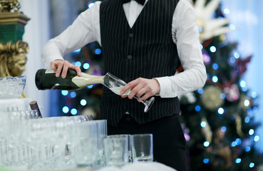 Waiter pouring glasses of champagne