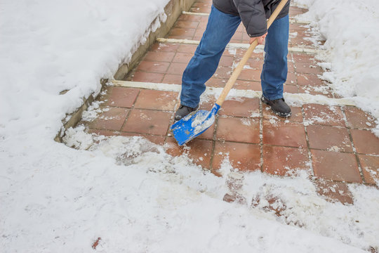 Man Shovelling Snow From The Sidewalk 2